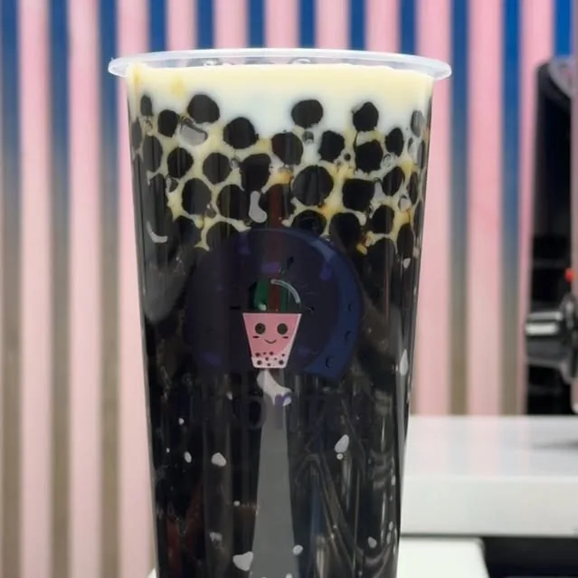 Dark Moonies milk tea filled with glossy tapioca pearls