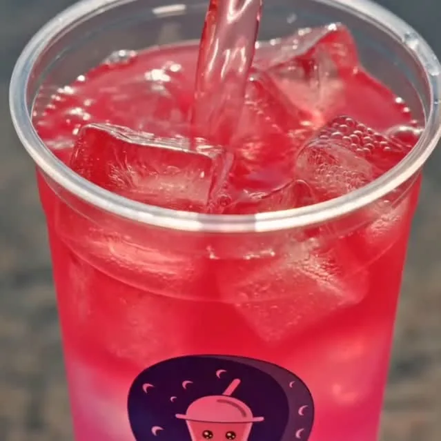 Bright red Moonies lemonade poured over ice